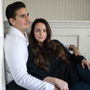 A man sitting on a couch with a woman sitting on top of him